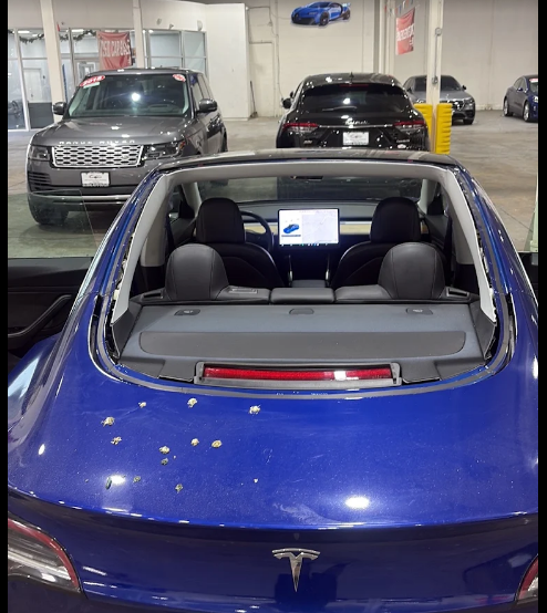 AZ Auto Glass technician inspecting a Tesla for auto glass service at a dealership
